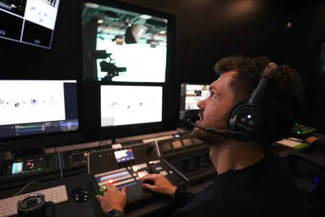 DreamOn Studios staff member wearing headphones looking at monitor while working with KEDCO.